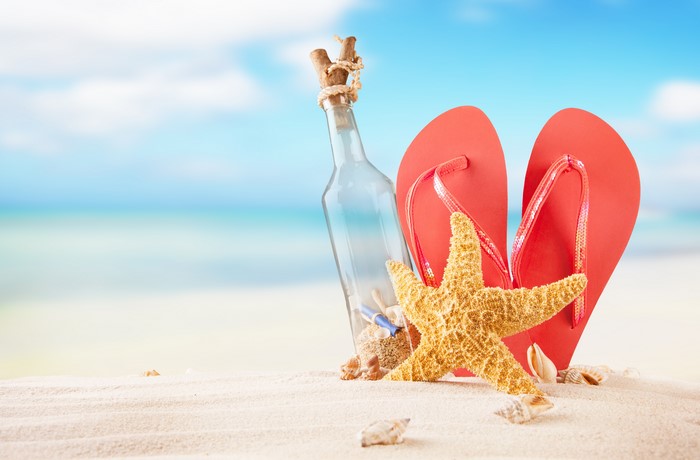 Starfish, Flip-flops, and Message in a Bottle on Beach