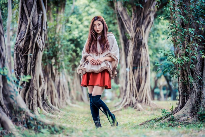 Asian woman posing in a forest