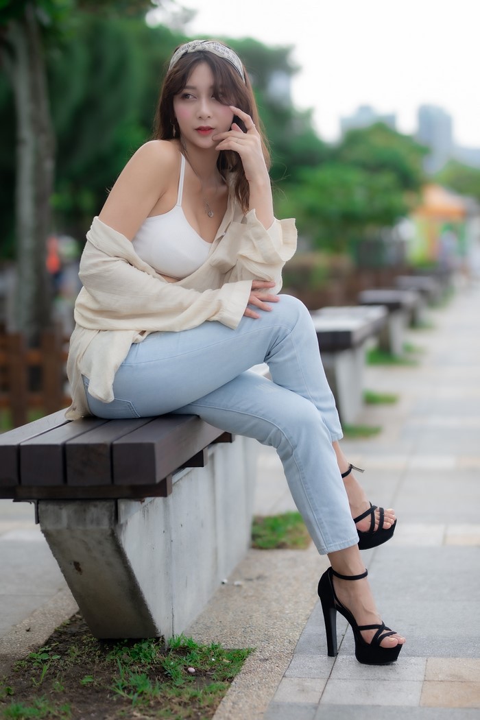 Asian woman sitting on a bench