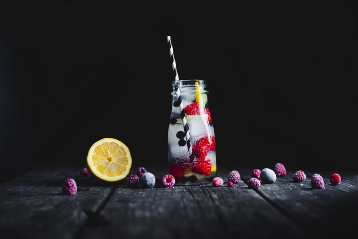 4K Drink with Berries and Lemon on Wood