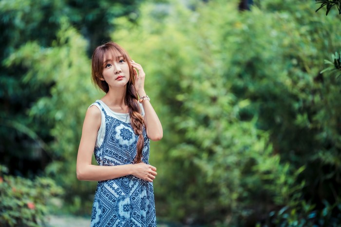 Asian woman with braid hair in a blue dress