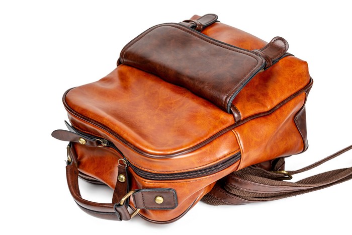 Brown leather backpack on white background
