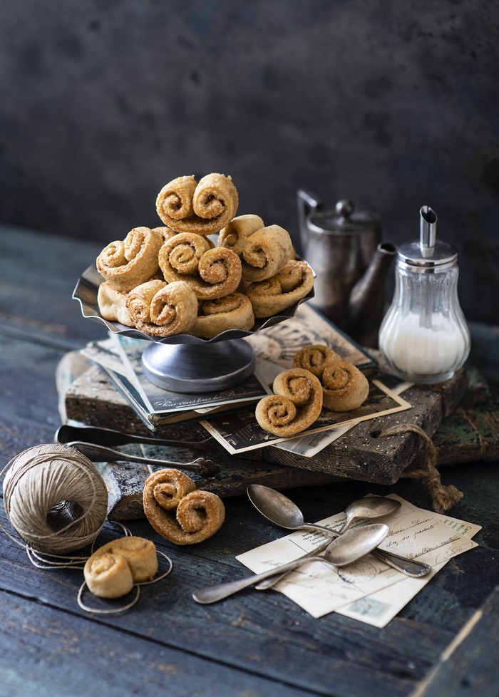 Palmiers pastries on a cake stand with vintage items