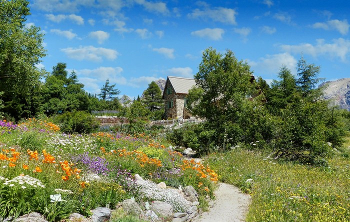 Stone house with a flower garden and a path in Valloire, France