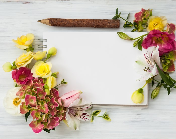 Notebook with flowers and pencil