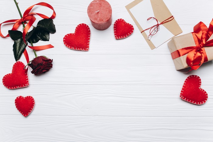 Valentine's Day flat lay with rose, gift, and hearts