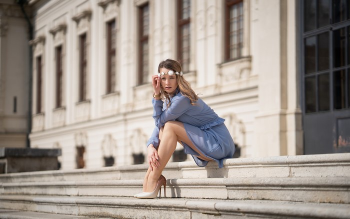 Justyna sitting on stairs with a wreath