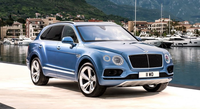 Blue Bentley Bentayga parked by a marina