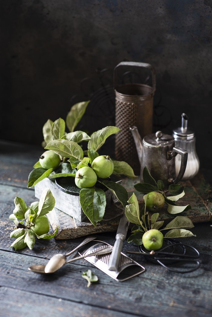 Still life with green apples and kitchenware