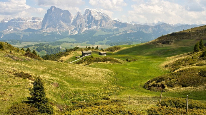 Mountain landscape with houses and snow-capped peaks