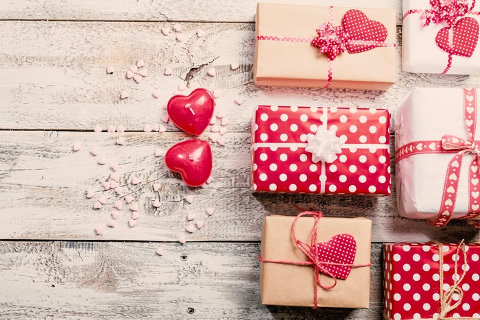 Valentine's Day gifts and heart candles on wood