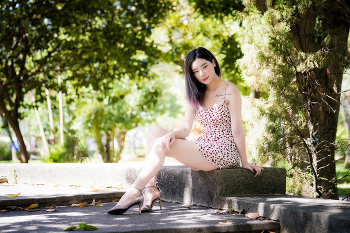 Asian woman sitting in a park