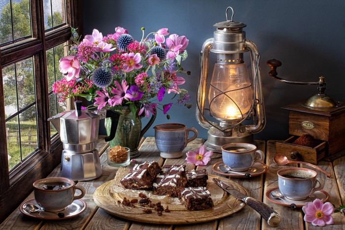 Still-life with coffee, cakes, flowers, and lantern