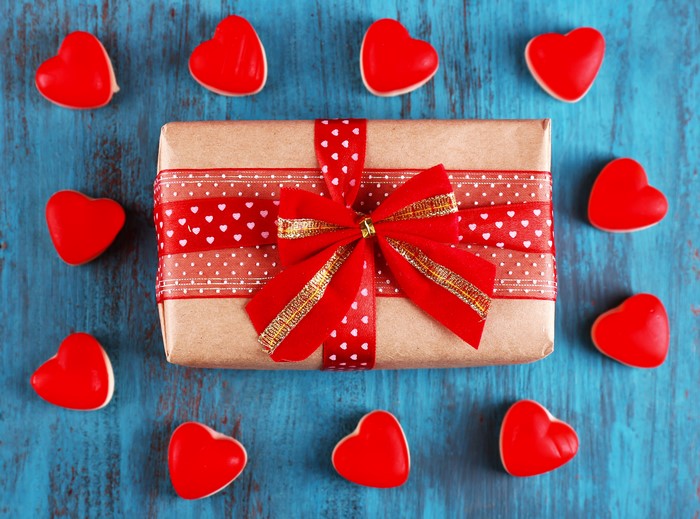Gift box with red ribbon and hearts