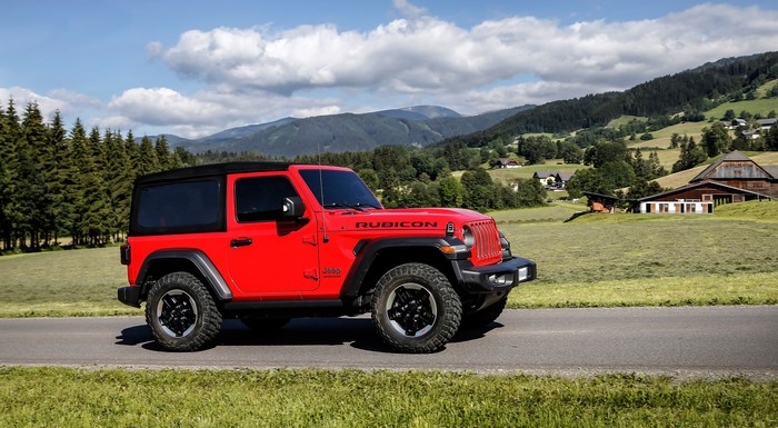 Red Jeep Wrangler Rubicon SUV on a road