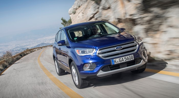 Blue 2016 Ford Kuga Titanium driving on a mountain road