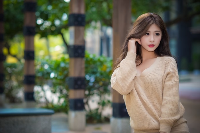 Asian woman with brown hair wearing a sweater