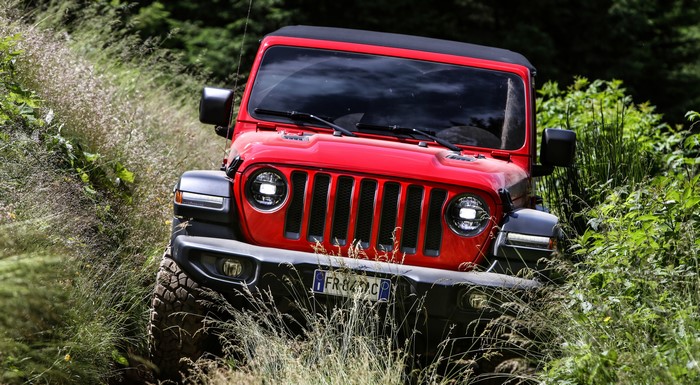 Red Jeep Wrangler Rubicon EU-spec driving off-road