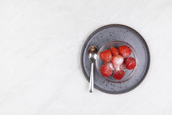 Strawberries with Sugar on a Plate with Spoon