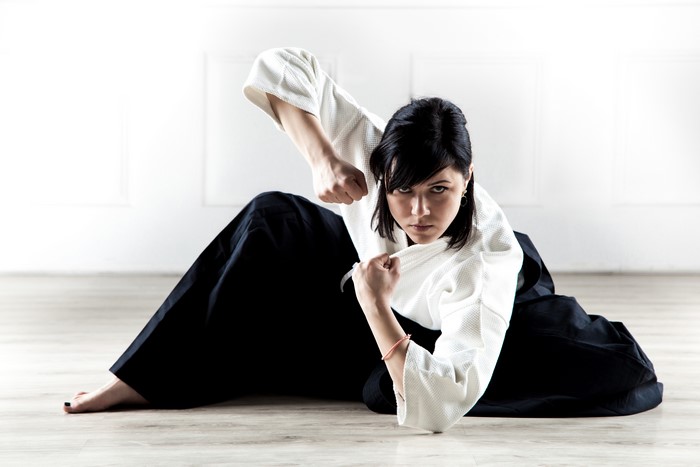 Brunette girl in Aikido kimono posing