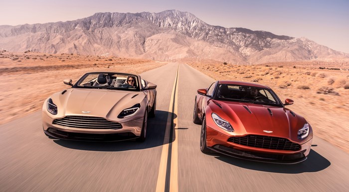 Two Aston Martin DB11 V8 Volante cars in motion