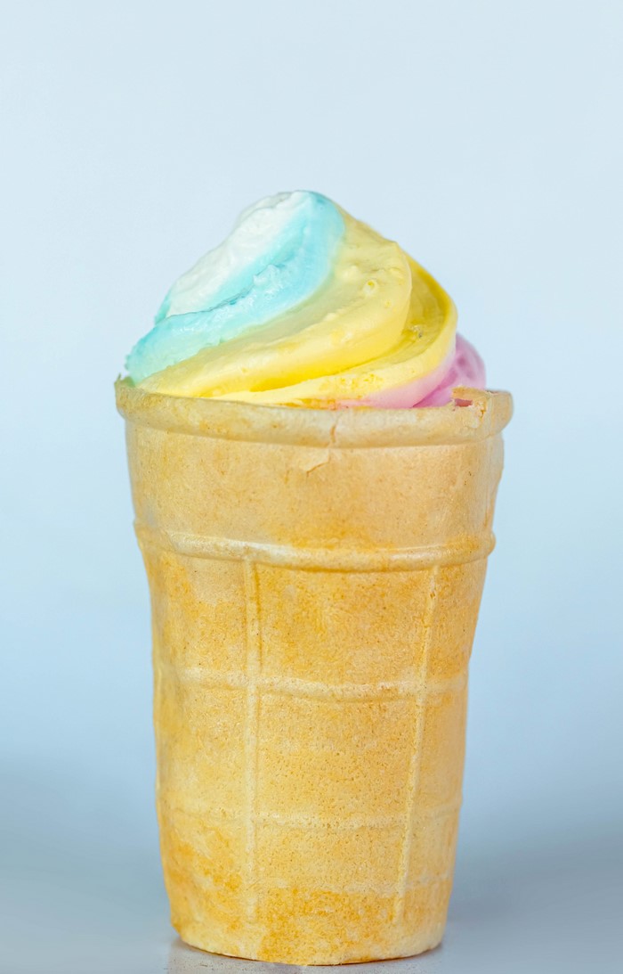 Multicolor ice cream in a waffle cone