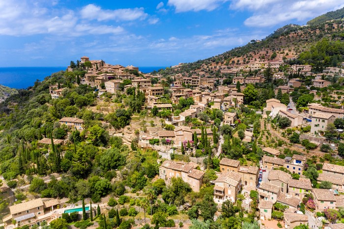 Hillside village with houses and the sea in Spain