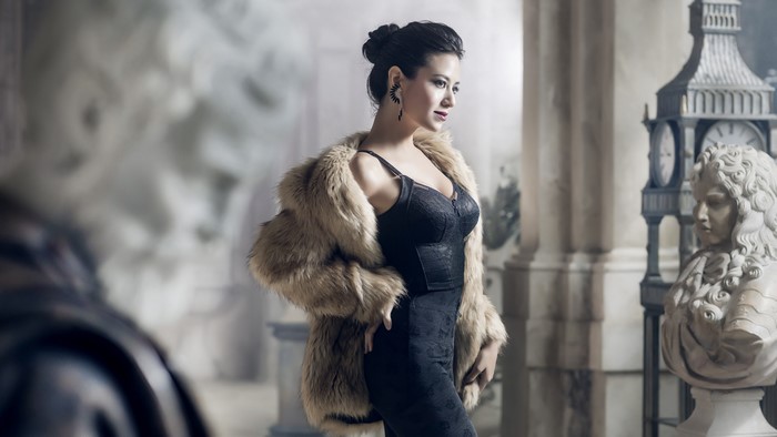 Woman in fur coat and dress with sculptures