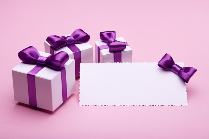 Gift boxes with violet bows and greeting card