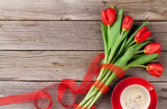 Red Tulips and Coffee on Wood Planks
