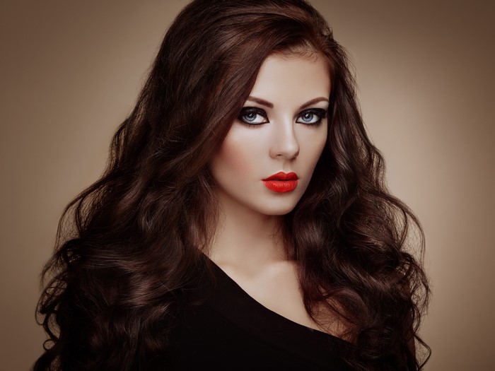 Beautiful woman with brown hair and red lips