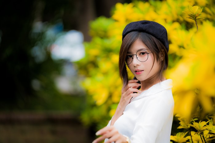 Asian woman with glasses and beret
