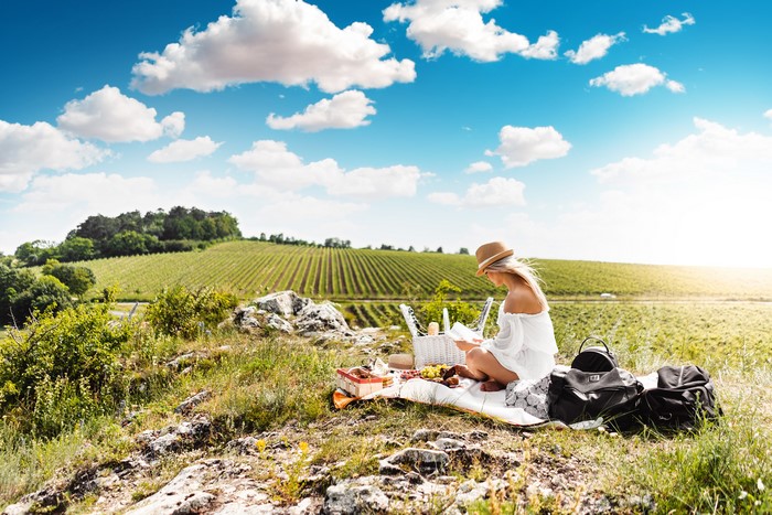 Woman having a picnic in a vineyard