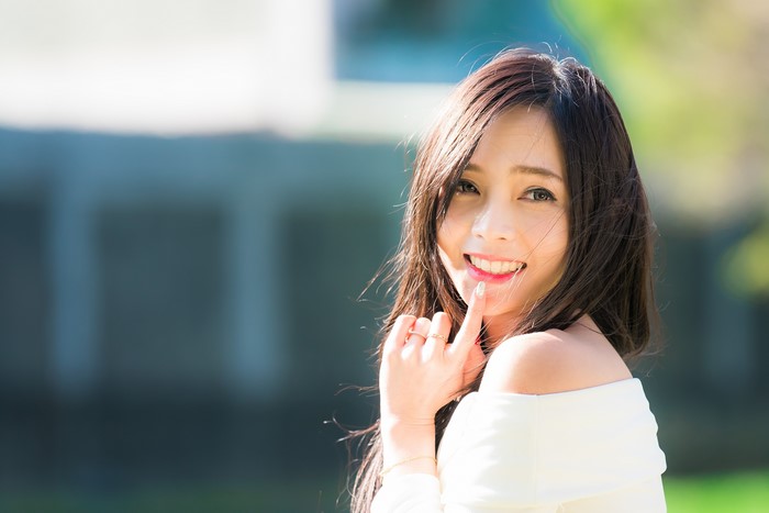 Asian woman with brown hair smiling