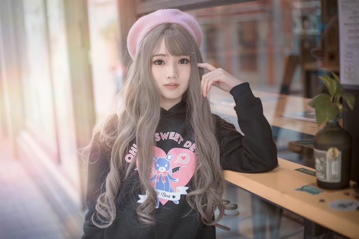 Asian girl with grey hair wearing a pink beret