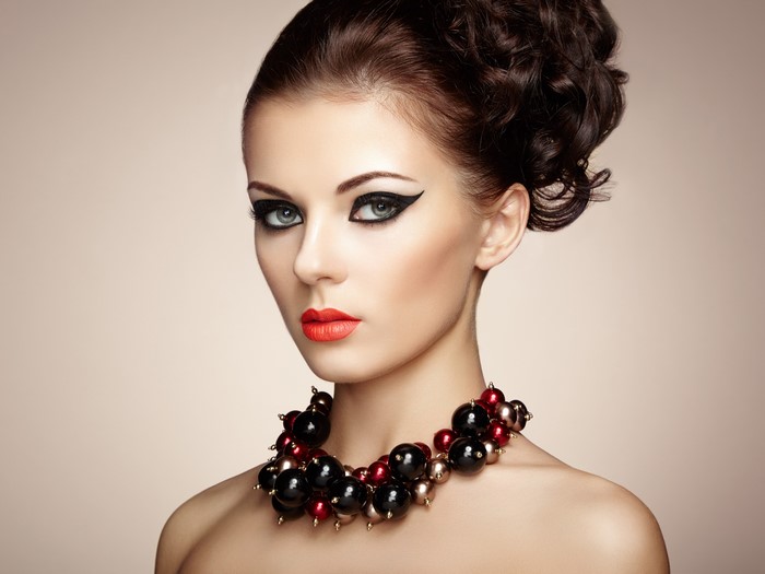 4K Model Wearing Bold Jewelry and Makeup