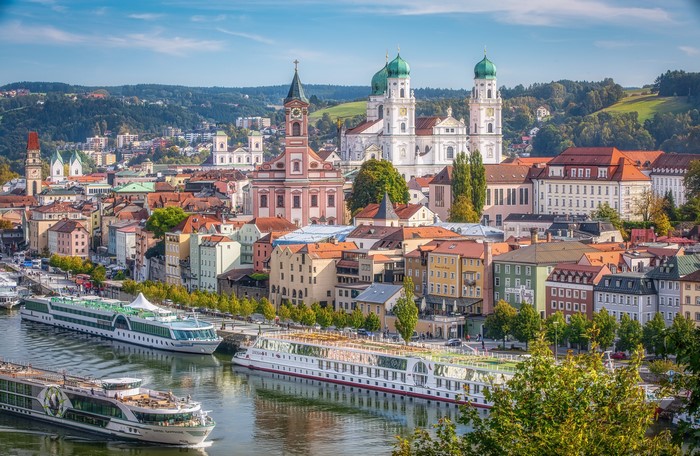 Passau, Germany riverfront with cruise ships and St. Stephen's Cathedral