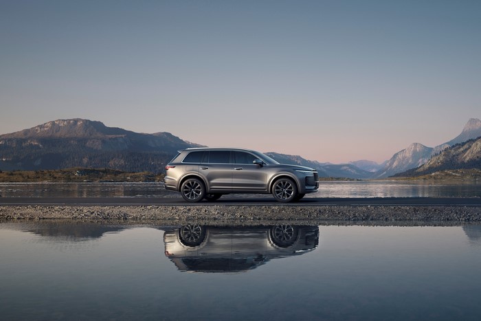 Lixiang ONE crossover reflected in water with mountains