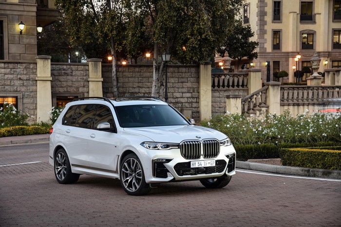 White BMW X7 M50d parked in front of a building
