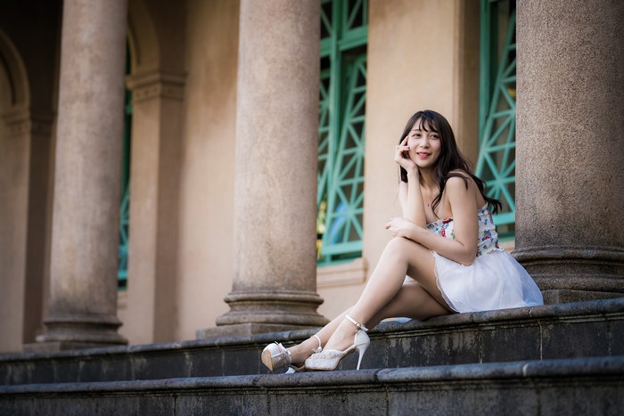 Asian woman sitting on stairs