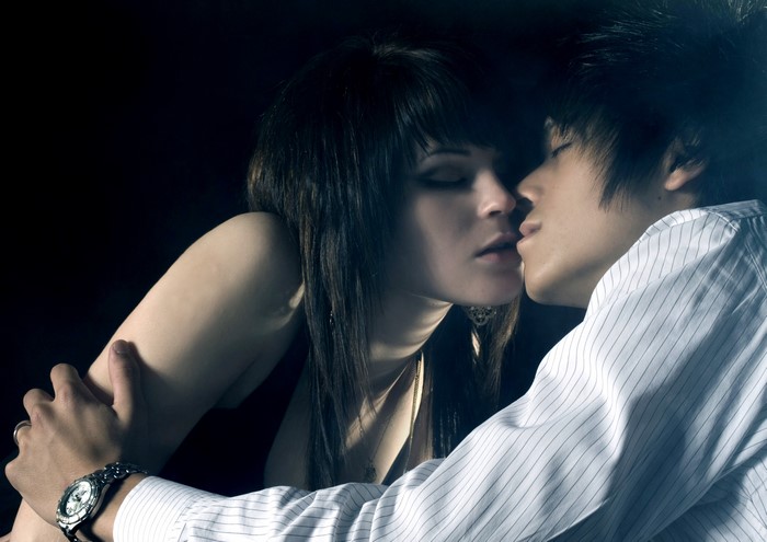 Couple kissing with man wearing a watch