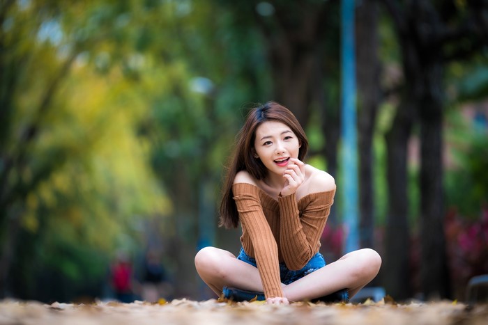 Woman sitting in lotus position outdoors