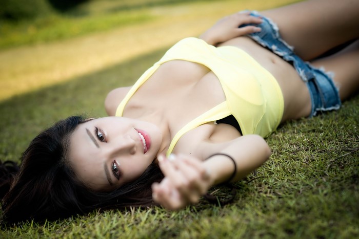 4K Asian Brunette Girl Lying on Grass