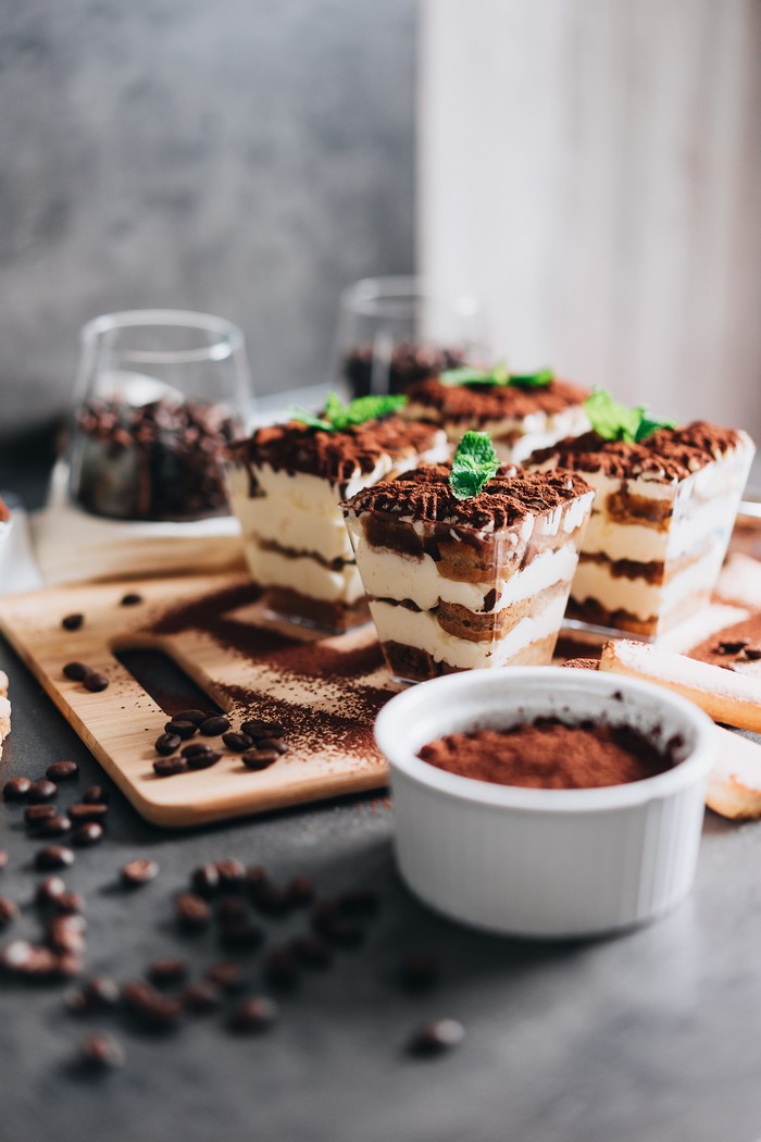 Tiramisu desserts with coffee beans and cocoa powder