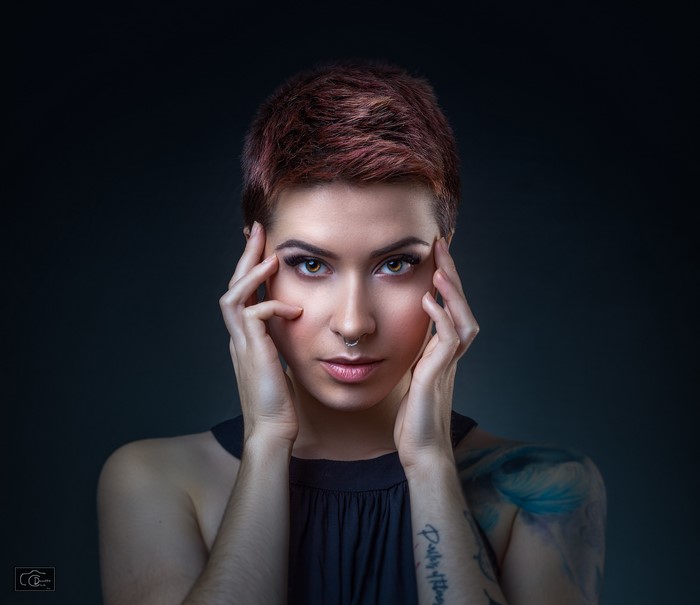Woman with short red hair and nose ring