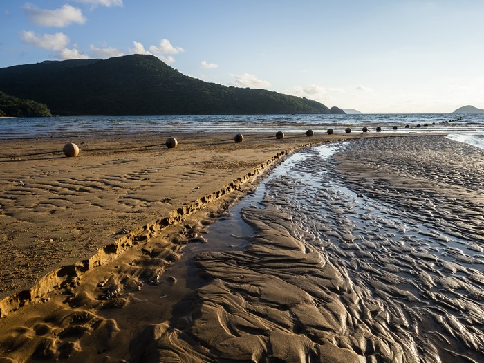 Beach with buoys and mountains in Vietnam