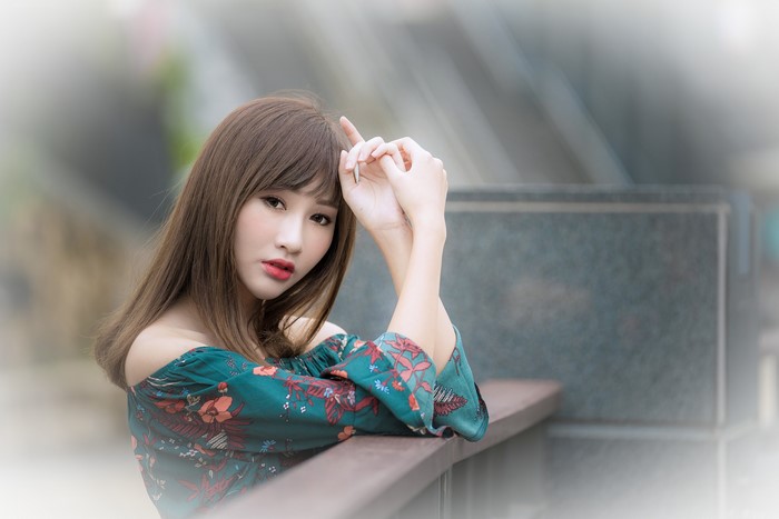 Asian woman with brown hair and floral top