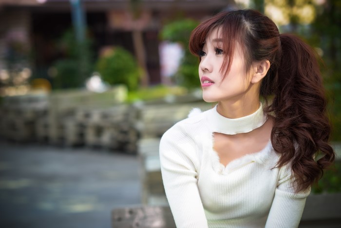 Asian woman with brown hair in a ponytail