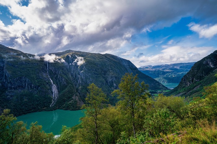 Waterfall flowing into a fjord in Folgefonna National Park, Norway