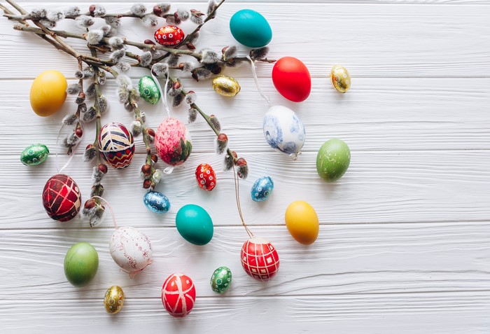Easter Eggs and Pussy Willow Branches on Wood Planks